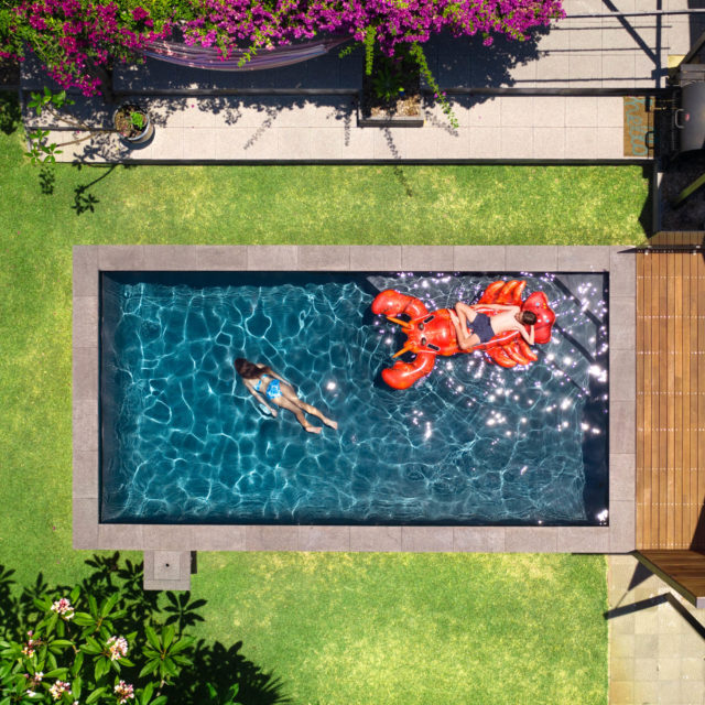 Backyard-aerial-pool-portrait-shot