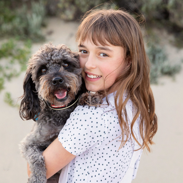 girl-and-her-dog-hugging-at-the-beach-01